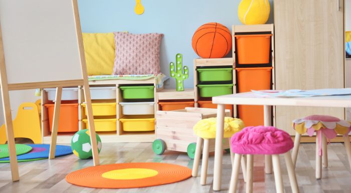 preschool furniture with tables and chairs and colourful shelves