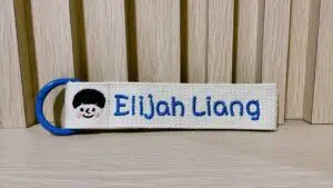 customised bag tag with colour and boy face with name